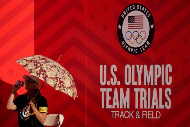 PHOTO: A race worker drinks water at the U.S. Olympic Track and Field Trials, June 26, 2021, in Eugene, Ore.  (Ashley Landis/AP)