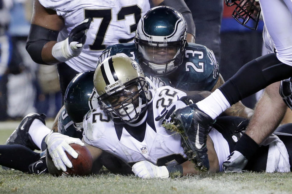 New Orleans Saints' Mark Ingram (22) scores a touchdown as Philadelphia Eagles' Patrick Chung (23) defends during the second half of an NFL wild-card playoff football game, Saturday, Jan. 4, 2014, in Philadelphia. (AP Photo/Matt Rourke)