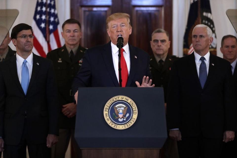 In a photo from Jan. 8, 2020,  as Secretary of Defense Mark Esper, Chairman of the Joint Chiefs of Staff Gen. Mark Milley, Vice President Mike Pence, and others look on, President Donald Trump addresses the nation from the White House on the ballistic missile strike that Iran launched against Iraqi air bases housing U.S. troops.