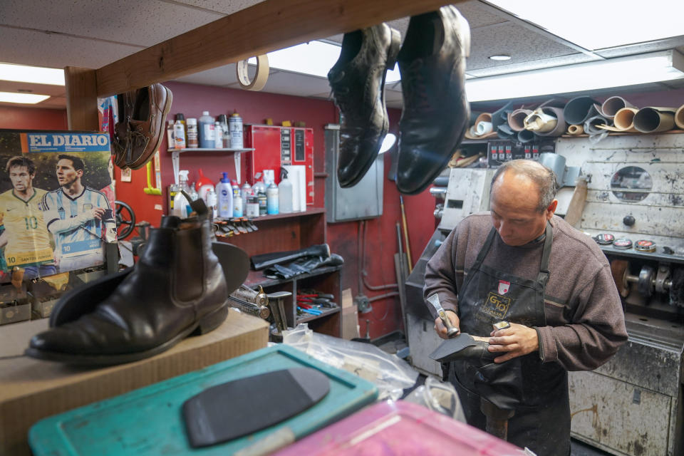 An employee repairs a pair of women's shoes at the Alpha Shoe Repair Corp., Friday, Feb. 3, 2023, in New York. Shoe repairs typically bring in more money than shines. (AP Photo/Mary Altaffer)