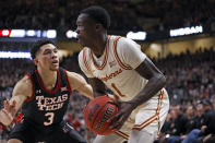 iTexas' Andrew Jones (1) shoots the ball around Texas Tech's Clarence Nadolny (3) during the first half of an NCAA college basketball game on Tuesday, Feb. 1, 2022, in Lubbock, Texas. (AP Photo/Brad Tollefson)