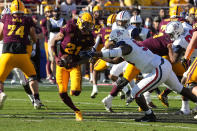 Arizona State wide receiver Elijhah Badger (21) runs away from Arizona defensive lineman Trevon Mason in the first half during an NCAA college football game, Saturday, Nov. 27, 2021, in Tempe, Ariz. (AP Photo/Rick Scuteri)