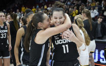 UConn forward Lou Lopez-Senechal (11) and guard Nika Muhl celebrate winning the championship over Iowa 86-79 in an NCAA college basketball game in the Phil Knight Legacy tournament in Portland, Ore., Sunday, Nov. 27, 2022. (AP Photo/Craig Mitchelldyer)