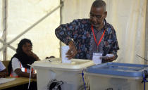 Presidential candidate for Alliance for Change and Transparency, Seif Sharif Hamad, casts his vote in Zanzibar Tanzania, Wednesday. Oct.28, 2020. Tanzania's other top opposition party, ACT Wazalendo, accused police of shooting dead nine people in the semi-autonomous region of Zanzibar. (AP Photo)