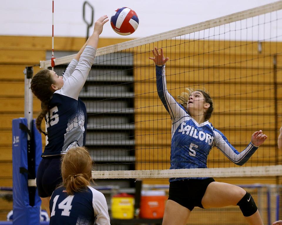 Plymouth North's Olivia Mackinnon looks to block the tip of Scituate's Evelyn Flynn during third set action of their match against Scituate at Scituate High on Wednesday, Oct. 5, 2022. 