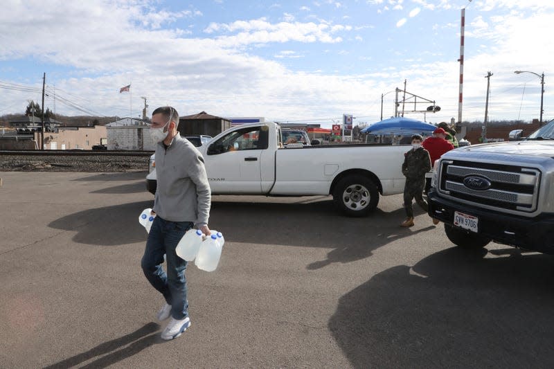 A resident of East Palestine, Ohio seen with several gallons of water more than 2 weeks after the train derailment 