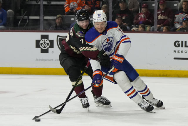 Edmonton Oilers center Nick Bjugstad (72) shields Arizona Coyotes defenseman Victor Soderstrom (77) from the puck in the first period during an NHL hockey game, Monday, March 27, 2023, in Tempe, Ariz. (AP Photo/Rick Scuteri)