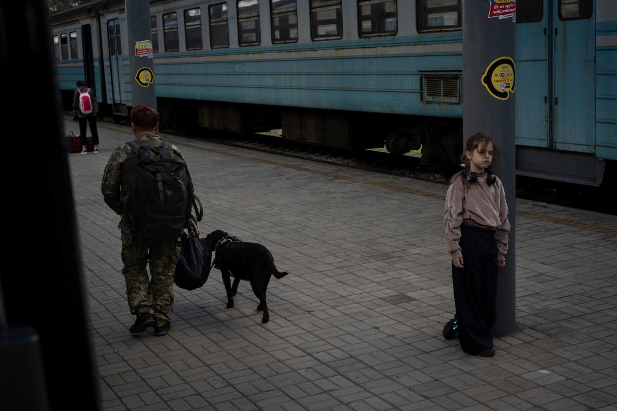 A girl stands on the platform at the railway station in Sloviansk, Donetsk region (AP)