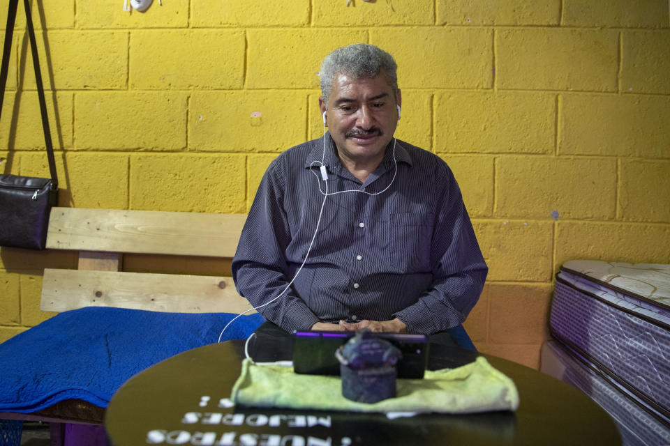 Fabio Rodolfo Vasquez is interviewed by a Mexican journalist online in his mother-in-law's home in the San Pedrito neighborhood of Guatemala City, Thursday, Sept. 17, 2020. Vasquez and his wife, Maria Moreno, entered an online dance contest during the new coronavirus pandemic to help them cope with the recent death of their daughter — and won it. (AP Photo/Moises Castillo)