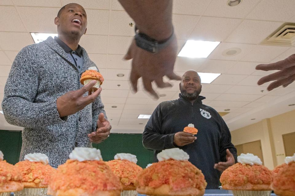 Donavon "Monty" Alderman of Monty's Neighborhood Snacks interacts with visitors who have each taken one of his strawberry cupcakes on Wednesday, Dec. 7, 2022.