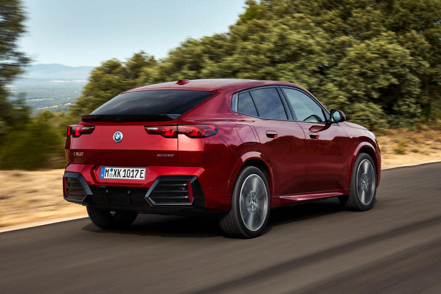 Red 2024 BMW iX2 – rear quarter tracking