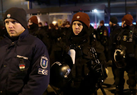 Policemen stand outside the headquarters of the Hungarian state television during a protest against a proposed new labor law, billed as the "slave law", in Budapest, Hungary, December 17, 2018. REUTERS/Marko Djurica