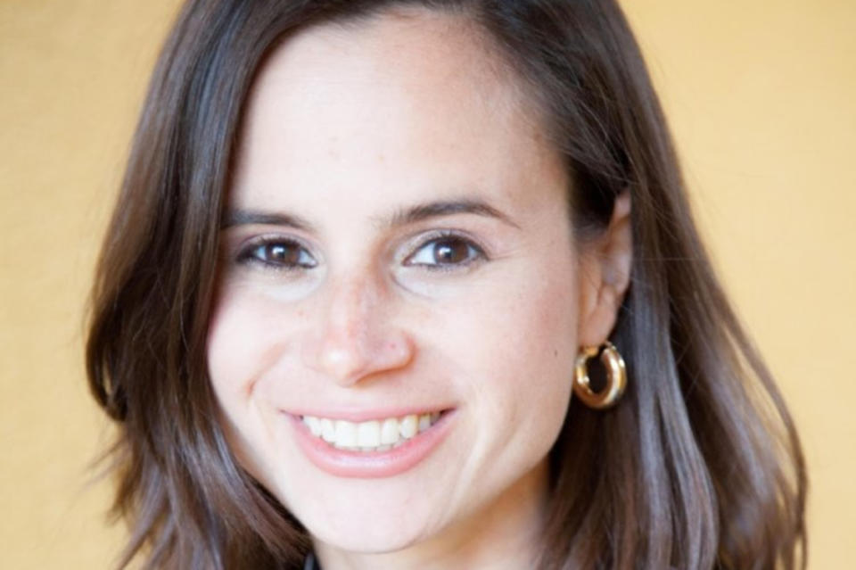 Headshot of Dr. Jess Carbino against a yellow background