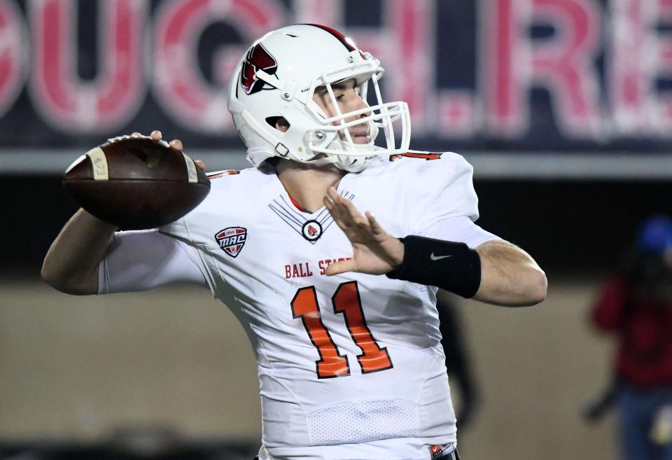 Ball State Cardinals quarterback Drew Plitt (11) drops back to pass against the Northern Illinois Huskies during the second quarter at Huskie Stadium in 2017.