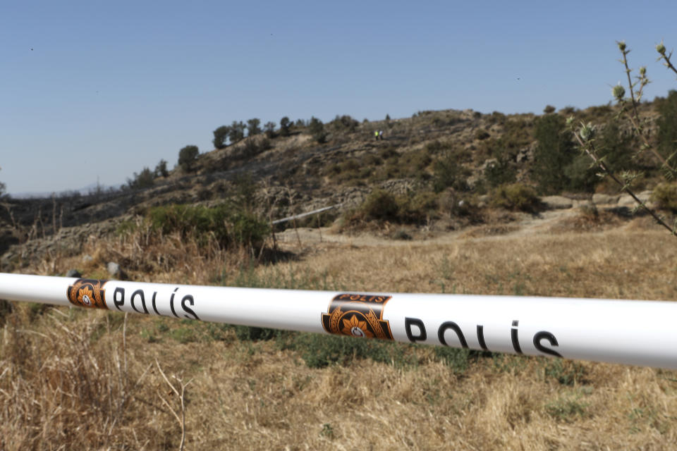 Turkish Cypriot police cordon off the area after an explosion pre-dawn, outside of village of Tashkent in the Turkish Cypriot breakaway north part of the divided Cyprus, Monday, July 1, 2019. A Turkish Cypriot official said Monday that a Syrian anti-aircraft missile that missed its target and reached ethnically divided Cyprus may have been the cause of an explosion outside a village in east Mediterranean island notion's breakaway north. No injuries were reported. (AP Photo/Petros Karadjias)