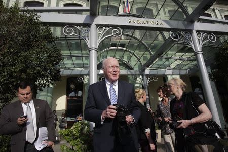 U.S. Senator Patrick Leahy (C), head of a U.S. delegation in the first congressional mission to Cuba since the change of policy announced by U.S. President Barack Obama on December 17, takes pictures outside a hotel in downtown Havana, January 19, 2015. REUTERS/Stringer