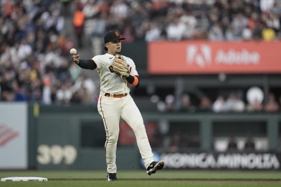 San Francisco Giants second baseman Isan Díaz throws to first for an out against Arizona Diamondbacks' Christian Walker during the fourth inning of a baseball game Monday, July 31, 2023, in San Francisco. (AP Photo/Godofredo A. Vásquez)