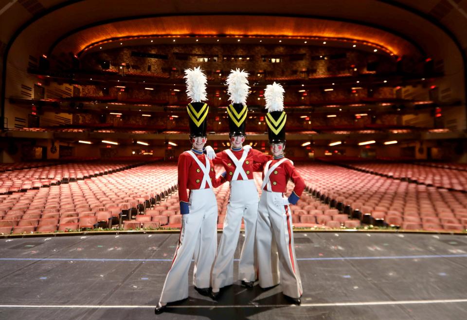 Radio City Rockettes Bailey Callaha left, Sydney Mesher, and Kristen Smith, on stage dressed for the "Parade of the Wooden Soldiers" musical number of the Radio City Christmas Spectacular Nov. 30, 2021.