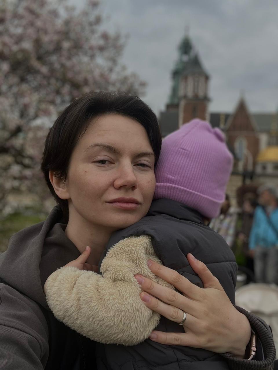 Woman holding a little girl and looking at the camera