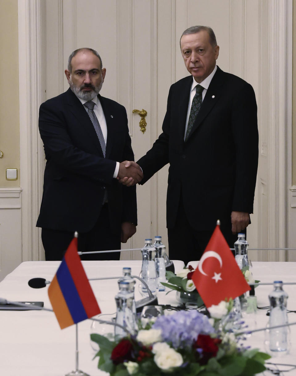 Turkey's President Recep Tayyip Erdogan, right, and Armenia's Prime Minister Nikol Pashinyan shake hands before a meeting at Prague Castle in Prague, Czech Republic, Thursday, Oct. 6, 2022. Erdogan and Pashinyan met in Prague on the sidelines of a summit by the leaders of 44 countries to launch a "European Political Community" aimed at boosting security and economic prosperity across Europe. (Turkish Presidency via AP)