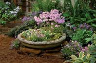 <p>We're making our list of Container Gardening Ideas great with a tip that will have you thinking outside the box—or planter. Consider using a cast-concrete pool for a miniature garden. You’ve probably already considered these for many other garden design applications, but they are far better suited to container gardening than you might have imagined. Because these pools are made to accommodate plumbing, there are already holes in the bottom that allow for drainage. Make use of what seems like a fortuitous accident, and capitalize on their often-wonderful designs. Then place plants like hostas, violas, and blue phlox straight in. They’ll grow wonderfully in their new pool that’s become a smart new planter.</p>