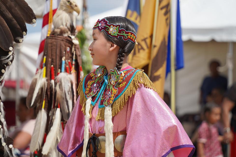 Maycie TwoCrow observes last year's Kchi Wiikwedong Anishinaabek Pow Wow at the National Cherry Festival in Traverse City. Her mother, Samantha TwoCrow, co-founded the Wiigwaasmin Pageant that culminates the annual pow wow.