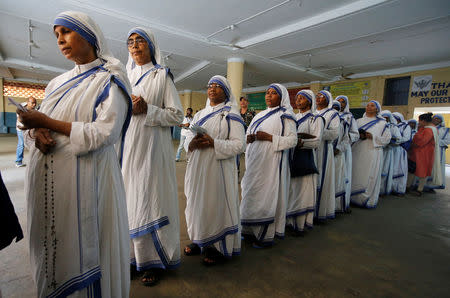 Catholic nuns from the Missionaries of Charity stand in a queue as they wait to cast their vote at a polling station during the final phase of general election in Kolkata, India, May 19, 2019. REUTERS/Rupak De Chowdhuri