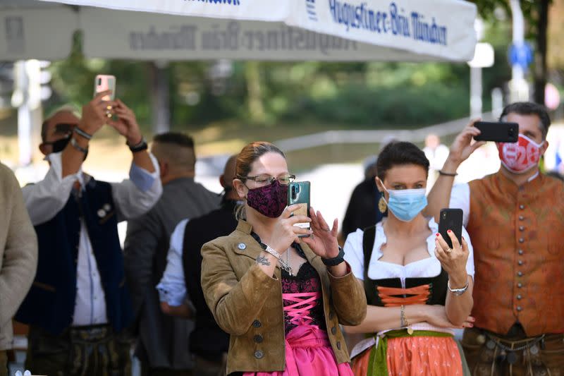 People take pictures at barrel tapping at beer garden near Theresienwiese, Munich