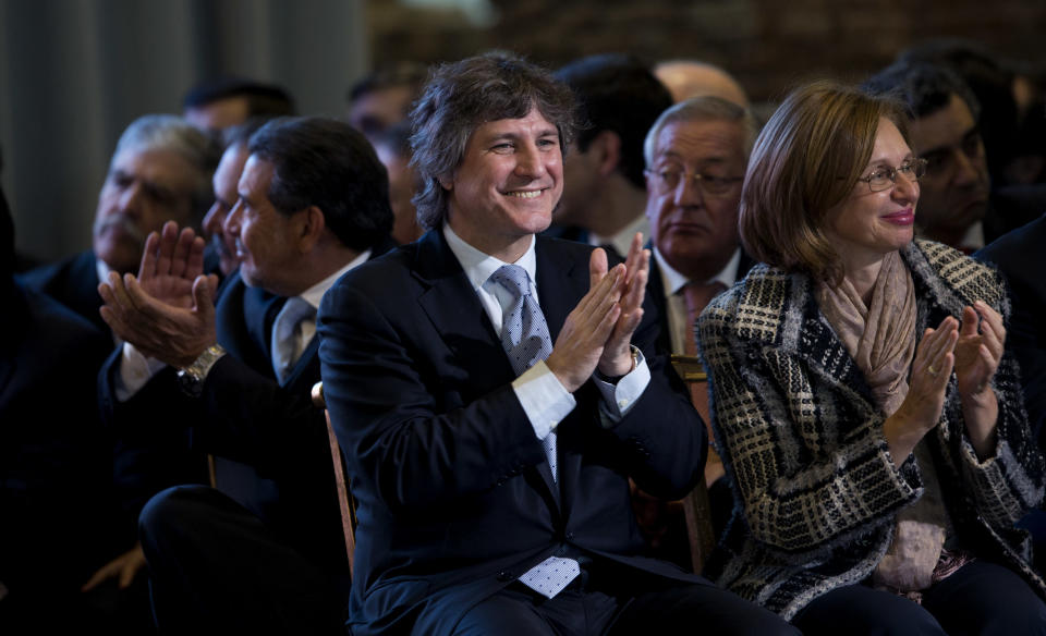 Argentina's Vice President Amado Boudou, center, and the head of the Senate Beatriz Rojkes de Alperovich, right, applaud as President Cristina Fernandez announces the creation of a development center for the nation's audiovisual industry at the government house in Buenos Aires, Argentina, Wednesday, Aug. 29, 2012. Fernandez unveiled an ambitious new plan to support the country's television and film creators with a new industrial park along the capital's waterfront that she hopes will be modeled on Hollywood's studios. (AP Photo/Natacha Pisarenko)