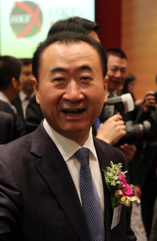 Wang Jianlin (C), CEO of Dalian Wanda Commercial Properties Co, arrives for the firm's IPO at the Hong Kong stock exchange on December 23, 2014