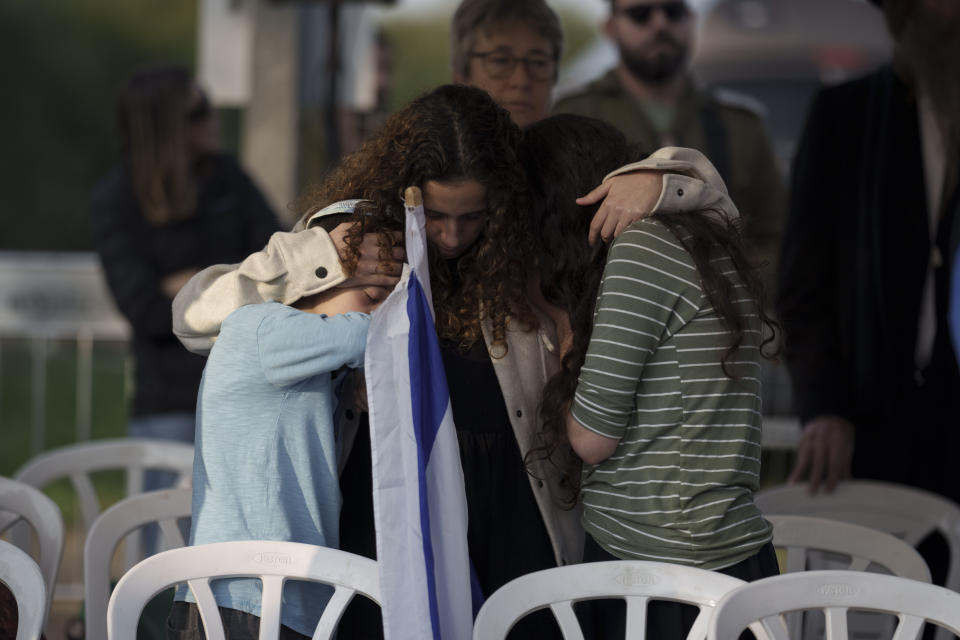 Relatives of the Israeli Captain Neriya Zisk mourn during his funeral, at a cemetery in the village of Masu'ot Yitzhak, Israel, Thursday, Dec. 28, 2023. Zisk was killed in combat in the Gaza Strip. (AP Photo/Leo Correa)