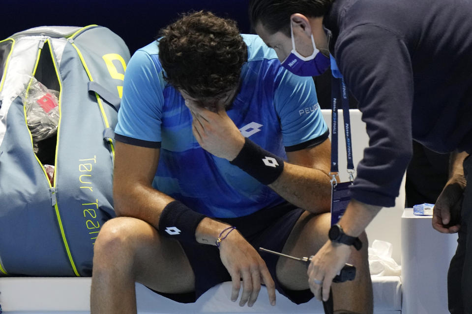 Italy's Matteo Berrettini gestures after injured as he plays Germany's Alexander Zverev during their ATP World Tour Finals singles tennis match, at the Pala Alpitour in Turin, Sunday, Nov. 14, 2021. (AP Photo/Luca Bruno)