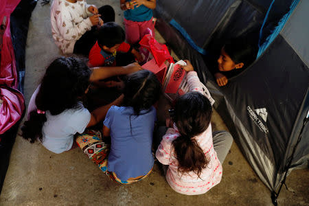 Children play outside a tent inside the shelter in Tijuana, Mexico April 6, 2019. Picture taken April 6, 2019. REUTERS/Carlos Jasso