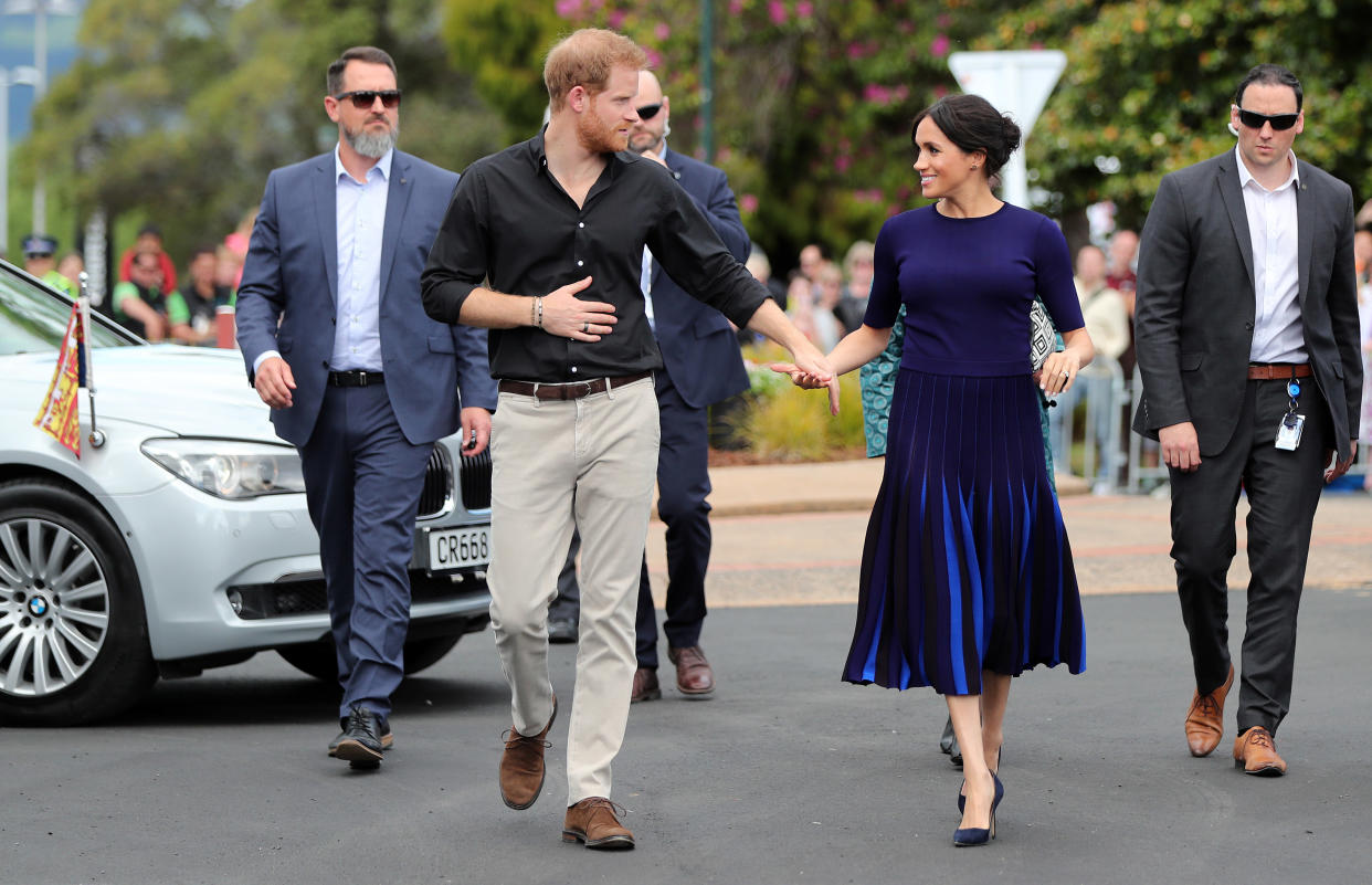 TOPSHOT - Britain's Prince Harry and Meghan, Duchess of Sussex arrive for a public walkabout at the Rotorua Government Gardens in Rotorua on October 31, 2018. - The Duke and Duchess of Sussex are on a three-week tour of Australia, New Zealand, Tonga, and Fiji. (Photo by MICHAEL BRADLEY / POOL / AFP)        (Photo credit should read MICHAEL BRADLEY/AFP/Getty Images)