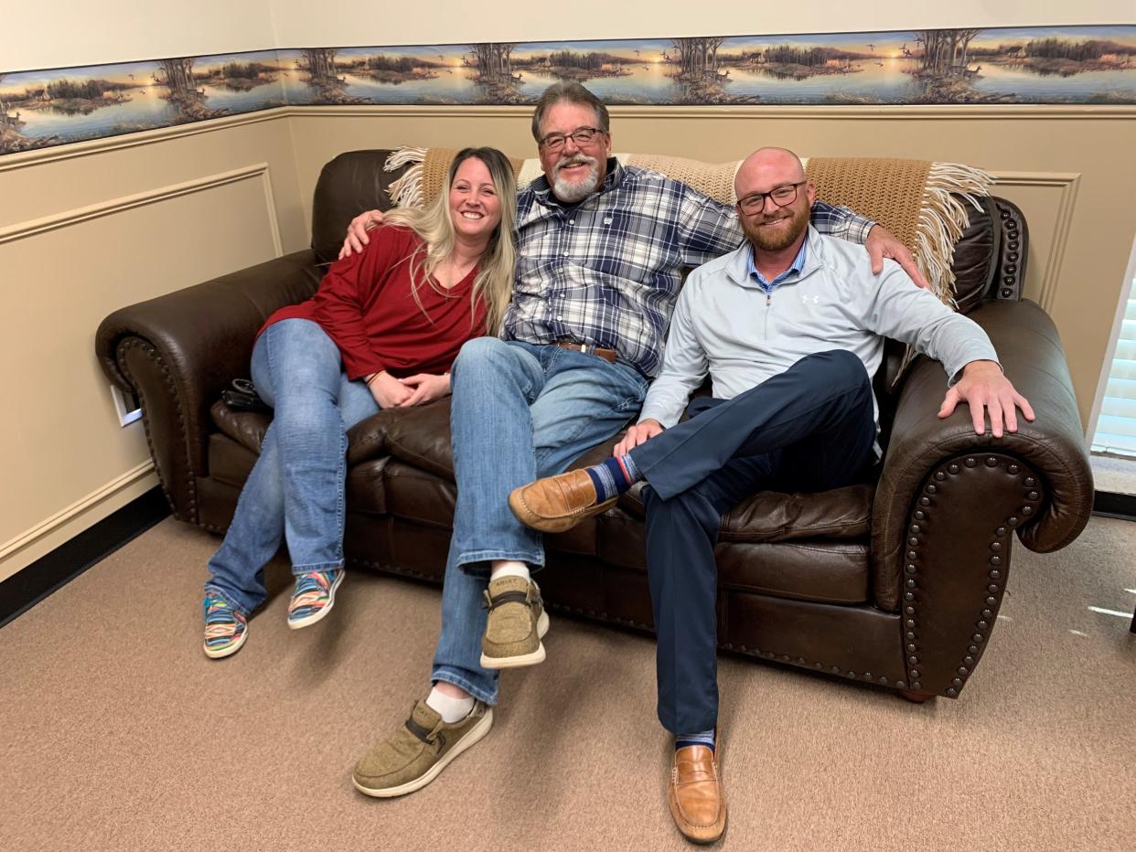 Founder of Love and Care Ministries Mark Hewitt, center, with daughter Magen Pitcock, clothing manager, and son Zack Hewitt, associate director, on March 13, 2024.