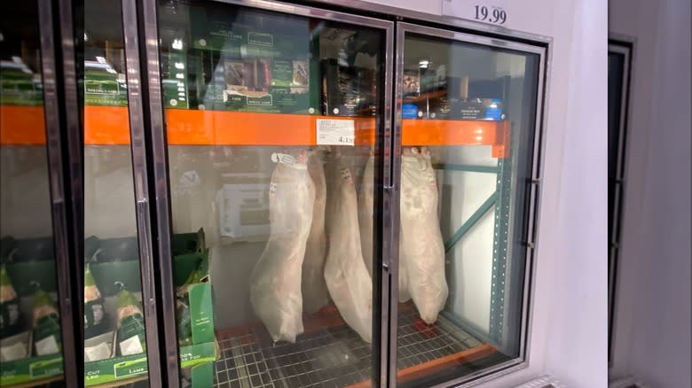 Meat hanging in a fridge