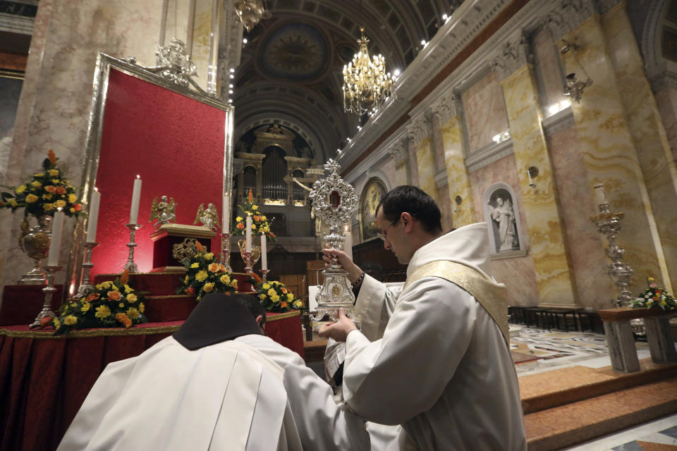 Christian clergymen carry a wooden relic believed to be from Jesus' manger at the Church of Saint Saviour in Jerusalem's old city, Friday, Nov. 29, 2019. Christians are celebrating the return to the Holy Land of a tiny wooden relic believed to be from Jesus' manger nearly 1,400 years after it was sent to Rome as a gift to the pope. (AP Photo/Mahmoud Illean)