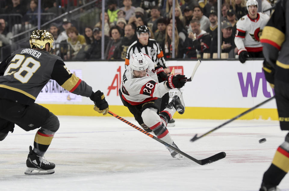 Ottawa Senators right wing Claude Giroux (28) shoots on goal against Vegas Golden Knights left wing William Carrier (28) during the first period of an NHL hockey game Sunday, Dec. 17, 2023, in Las Vegas. (AP Photo/Steve Marcus)