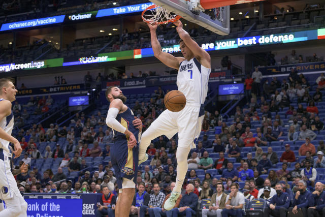 Dallas Mavericks center Dwight Powell (7) dunks on New Orleans Pelicans center Jonas Valanciunas during the first half of an NBA basketball game in New Orleans, Wednesday, Dec. 1, 2021. (AP Photo/Matthew Hinton)