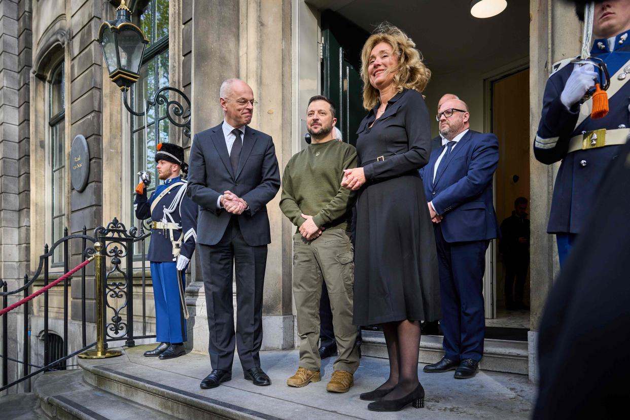 Ukrainian President Volodymyr Zelensky (C) poses next to Dutch Senate president Jan Anthonie Bruijn (L) and Dutch House of Representatives president Vera Bergkamp as he arrives for a meeting with members of the Senate and the House of Representatives, in The Hague (ANP/AFP via Getty Images)