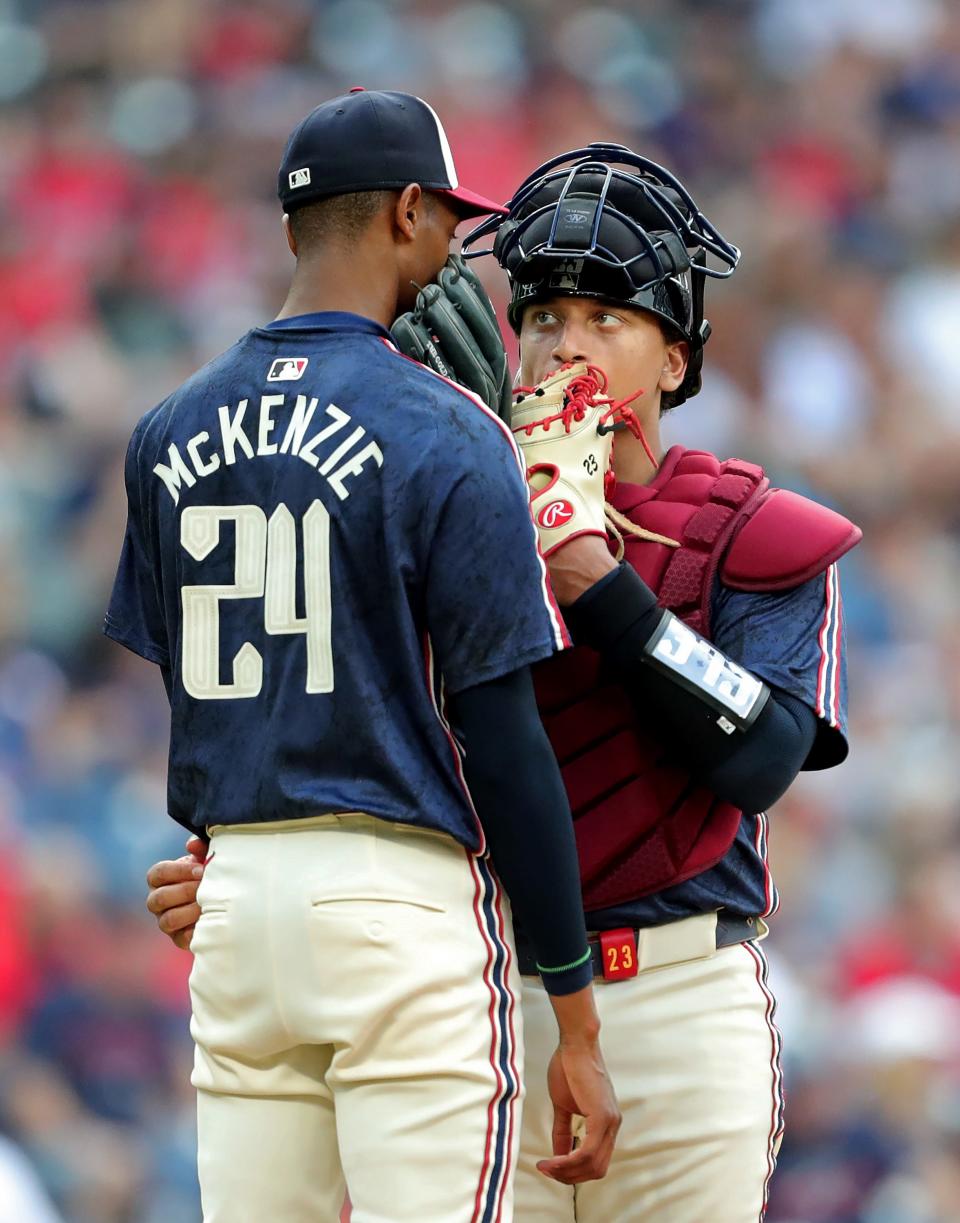 Cleveland Guardians catcher Bo Naylor (23) tries to calm down teammate Triston McKenzie (24) during the third inning Tuesday against the Seattle Mariners in Cleveland.