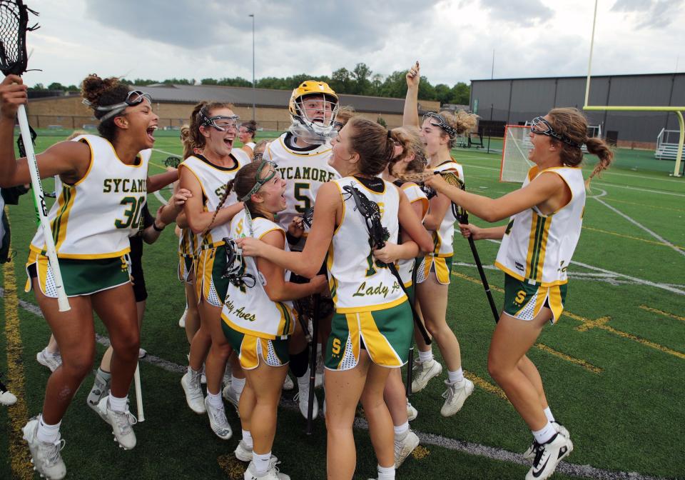 Sycamore players celebrate after winning the girls Division I lacrosse regional final game between Sycamore and Mason high schools May 25, 2022.