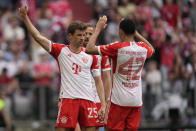 Bayern's Thomas Mueller, left, celebrates after scoring his side's second goal during the German Bundesliga soccer match between Bayern Munich and Cologne at the Allianz Arena in Munich, Germany, Saturday, April 13, 2024. (AP Photo/Matthias Schrader)