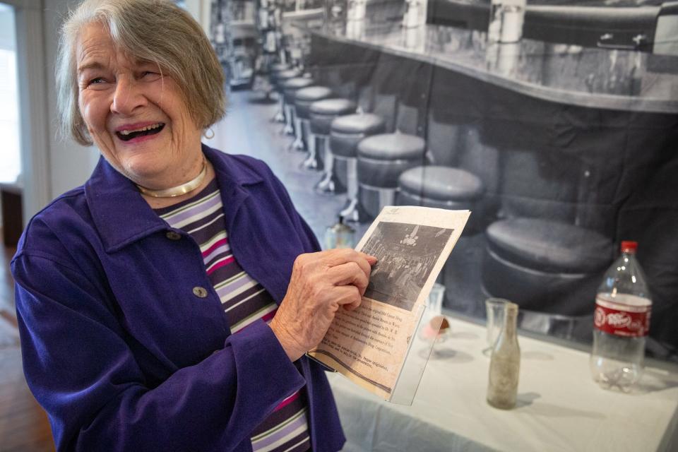 Pam Wheat Stranahan shows off an old photograph of a pharmacist and historical figure in Aransas County who worked at the pharmacy that invented Dr. Pepper, in an exhibit at the Historical Center on Friday, March 1, 2024, in Rockport, Texas.