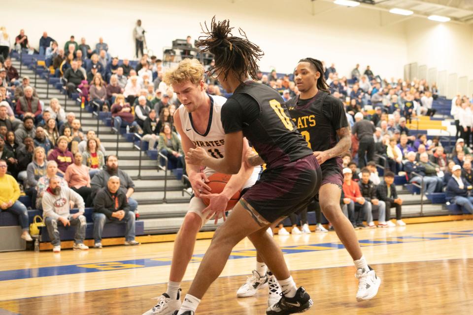 Pewamo-Westphalia senior Jamison Eklund and Brandywine junior Jamier Palmer struggle for the ball during the state quarterfinal game at Portage Central High School on Tuesday, March 21, 2023.