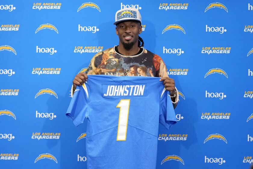 Quentin Johnston poses with his Chargers jersey.