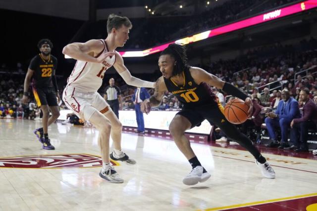 Arizona State guard Frankie Collins (10) dribbles the ball next to Southern California guard Drew Peterson.
