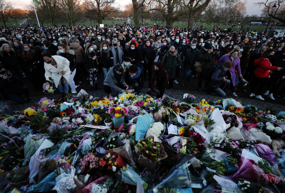 People gather, at the band stand in Clapham Common, in memory of Sarah Everard, after an official vigil was cancelled, in London, Saturday, March 13, 2021. A serving British police officer accused of the kidnap and murder of a woman in London has appeared in court for the first time. Wayne Couzens, 48, is charged with kidnapping and killing 33-year-old Sarah Everard, who went missing while walking home from a friend’s apartment in south London on March 3. (AP Photo/Frank Augstein)