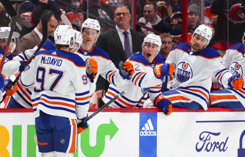 Edmonton Oilers center Connor McDavid (97) celebrates a goal with teammates while taking on the Ottawa Senators during the first period of an NHL hockey game in Ottawa on Saturday, Feb. 11, 2023. (Sean Kilpatrick/The Canadian Press via AP)