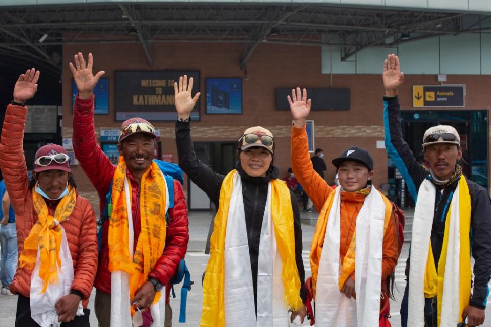 Tsang Yin-hung, 45, center, who became the fastest woman to ascend Everest in 2021; she reached the peak in just over 25 hours. AP